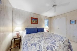 a bedroom with a blue and white bed and two lamps at Bethany Pines -- 412 Bethany Drive in Bethany Beach