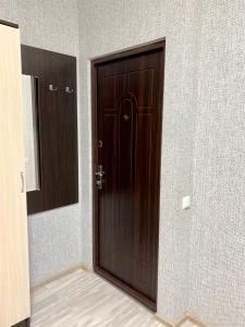 a wooden door in a room with a wall at Apartment room-біля вокзалу-недалеко від центру in Lviv