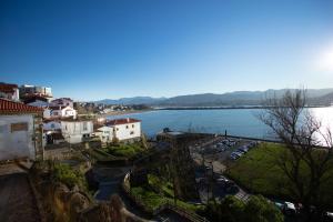 a view of a town with a river and buildings at El puerto viejo in Getxo