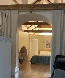 a bedroom with a bed in a room with an archway at Loft in Bungay in Bungay