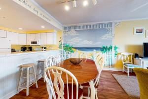 a kitchen and dining room with a table and chairs at Island Cabana in Ocean City