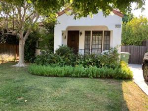 una pequeña casa blanca con un árbol en el patio en House, walking distance from Universal Studios en Los Ángeles
