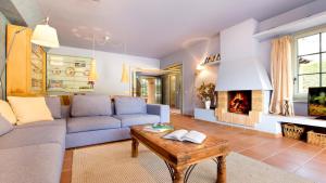 a living room with a couch and a fireplace at 1 Past2 - Llafranc in Llafranc