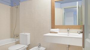 a bathroom with a toilet and a sink and a mirror at 1 Past2 - Llafranc in Llafranc +23 photos
