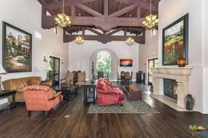 a large living room with furniture and a fireplace at Legacy Villa Resort- 48613 Classic Drive in La Quinta