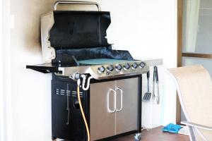 a kitchen with a grill and a stove top oven at Beach Side Secret in Ginoza +76 photos