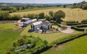 an aerial view of a large house in a field at Copse Gate Farm in Bridport