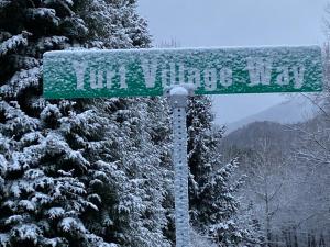 a green street sign with snow on it at Maggie Valley Cabin Rentals in Maggie Valley +96 photos