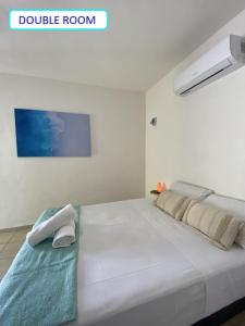 Postel nebo postele na pokoji v ubytování Casa Colibrí El Cuyo