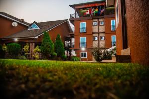 a building with a lawn in front of it at Homey Lodge in Kumasi