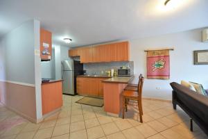 a kitchen with a couch and a table in a room at Seashore Condo in Rincon