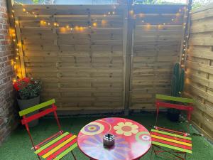 a patio with a table and two chairs and a table with at Mine d'Amour in Wallers