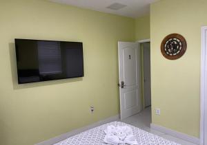 a bedroom with a flat screen tv on the wall at Casa Miami 1 in Miami