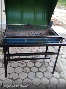 a metal bed with a green container on top at Blesshomestay Samosir in Sinabono +11 photos