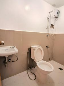 a bathroom with a toilet and a sink at E Relaxed Haven Transient House in Manila