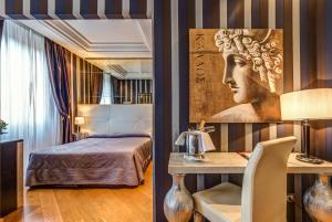 a bedroom with a bed and a desk with a head on the wall at Atlante Star Hotel in Rome