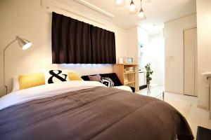 Postel nebo postele na pokoji v ubytování R-Guest Residence 東京浅草 east2