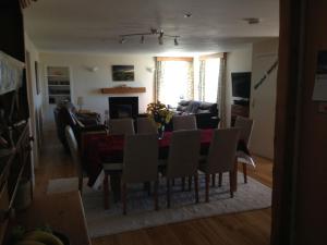 a dining room and living room with a table and chairs at Langside in Stirling