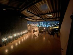 a room with chairs and a table with a view of the city at Casa Azul - Apartamentos Amoblados - in Manizales +67 photos