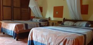 a bedroom with two beds in a room at Centro Ecoturistico Ya´ajche in Lacanjá