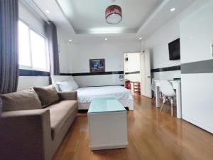 a living room with a bed and a couch at Saigon Apartments 2 in Ho Chi Minh City