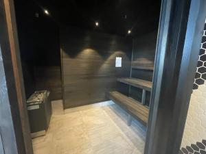 a empty room with a bench and a trash can at Movenpick Hotel Melbourne On Spencer in Melbourne