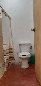 a bathroom with a white toilet in a room at Centro Ecoturistico Ya´ajche in Lacanjá