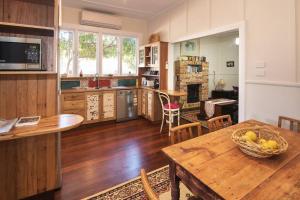 a kitchen with a table with a bowl of bananas on it at Heritage Cottage Margaret River in Margaret River Town