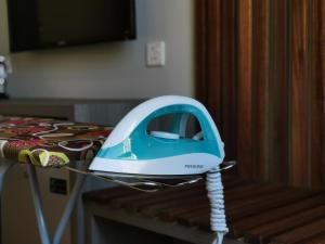 a blue and white iron sitting on top of a table at VENO HOTEL in George Town