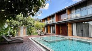 a house with a swimming pool next to a building at The Memory Khaoyai in Pong Talong