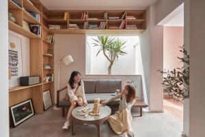 two girls playing a game in a living room at M Village Living Võ Thị Sáu in Ho Chi Minh City