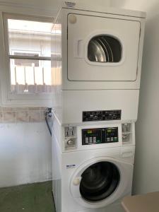 a washer and dryer in a room with a window at Tumut Apartments in Tumut
