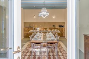 a dining room with a long table and chairs at Ca' Maggiolina B&B in Milan
