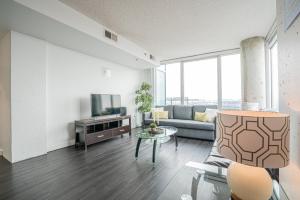 a living room with a couch and a tv at 2BR Furnished Apartment in Baltimore Downtown apts in Baltimore