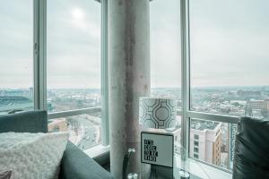 a room with a large window with a view of a city at 2BR Furnished Apartment in Baltimore Downtown apts in Baltimore +33 photos