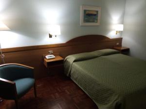 Postel nebo postele na pokoji v ubytování Hotel Arcadia