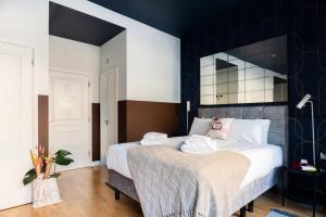 a bedroom with a large bed with black and white walls at Bob W Tower of London in London