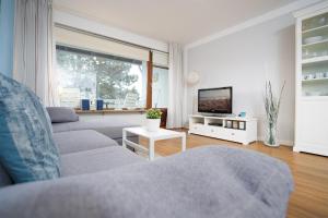 ein Wohnzimmer mit 2 Sofas und einem TV in der Unterkunft Haus Gorchfock Barke in Kellenhusen
