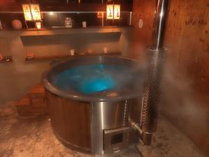 a large tub filled with blue water in a room at Guest House Sherpa in Moravská Třebová