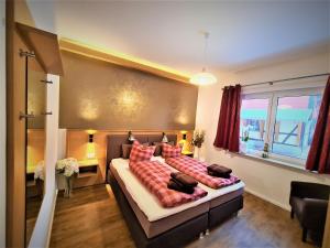 a bedroom with a large bed with red pillows at Ferienwohnungen Burgfried in Wernigerode