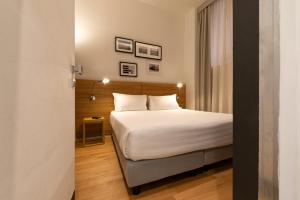 Postel nebo postele na pokoji v ubytování Coronari Palace