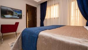 Postel nebo postele na pokoji v ubytování Souaré Premium Hôtel
