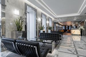 a row of black benches in a lobby at Hotel Congress in Vilnius