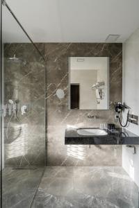 a bathroom with a sink, mirror and bath tub at Hotel Congress in Vilnius