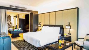 a hotel room with a large bed and a large mirror at InterContinental Pattaya Resort, an IHG Hotel - SHA Extra Plus in Pattaya South