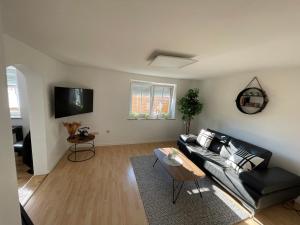 a living room with a couch and a table at D&D Apartment in Kolbermoor