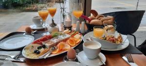 a table with a tray of breakfast foods and orange juice at Kuschelige Ferienwohnung in Schwandorf in Bayern +20 photos