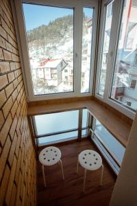 a room with two chairs and a large window at Apartman Vesna in Nova Varoš