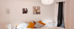 a bedroom with a bed and two pictures on the wall at Business Apartment Velizy Free parking by Servallgroup in Vélizy-Villacoublay