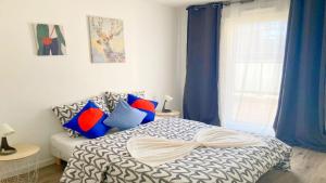 a bedroom with a bed with blue curtains and a window at Business Apartment Velizy Free parking by Servallgroup in Vélizy-Villacoublay